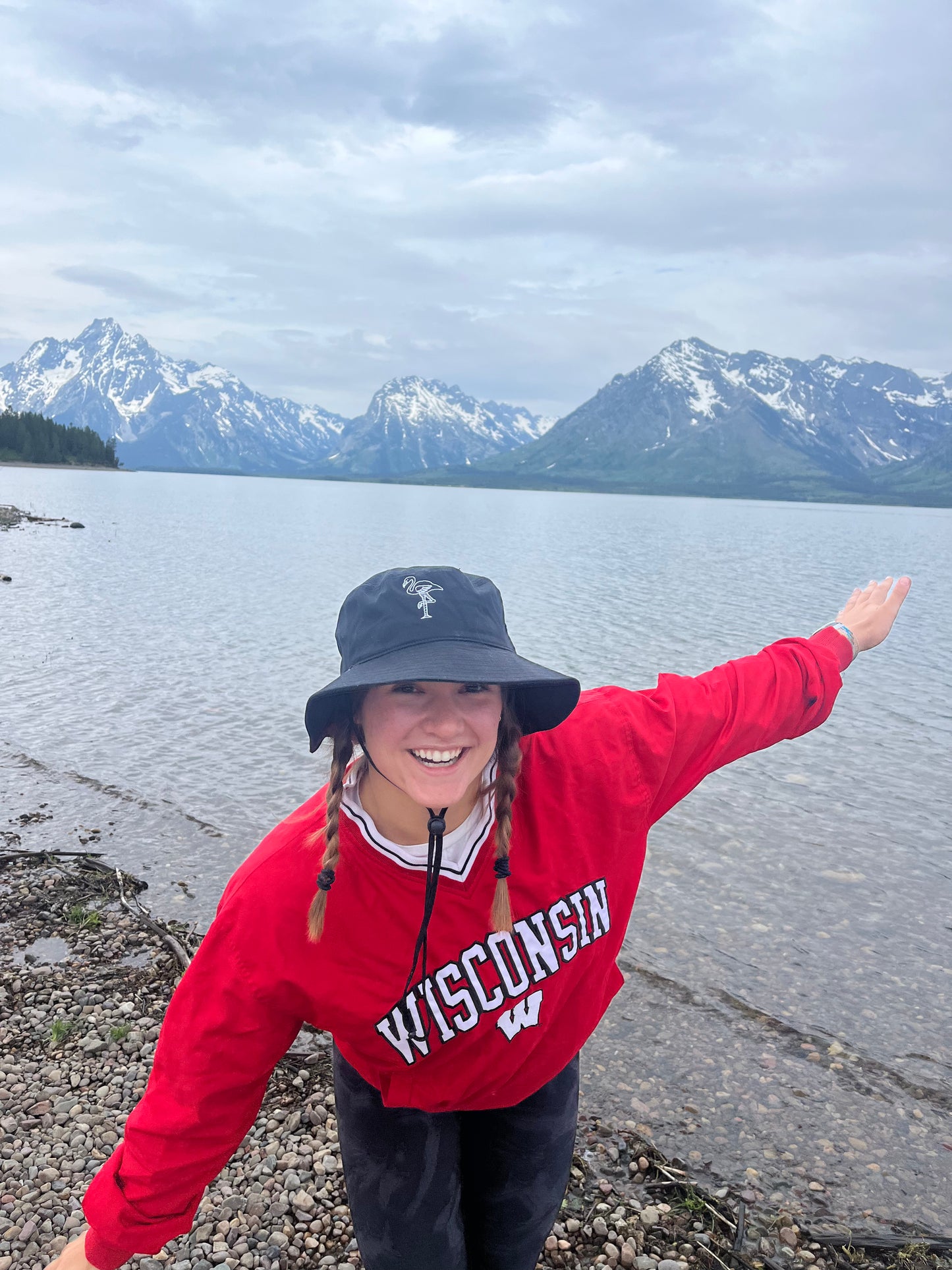 Member in bucket hat with mountains